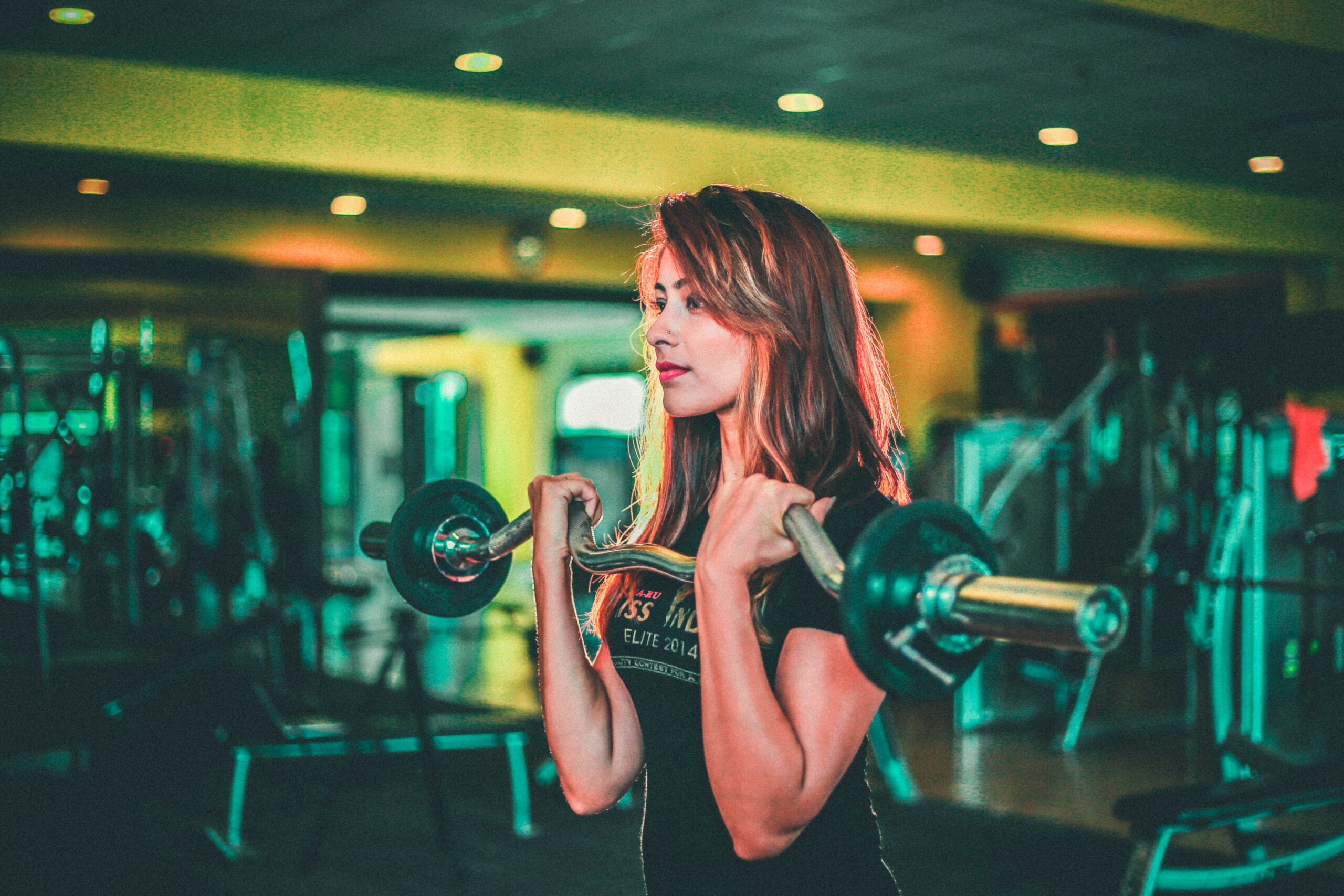 A photo of a woman lifting weights. An image that highlights the benefits of strength training for women.